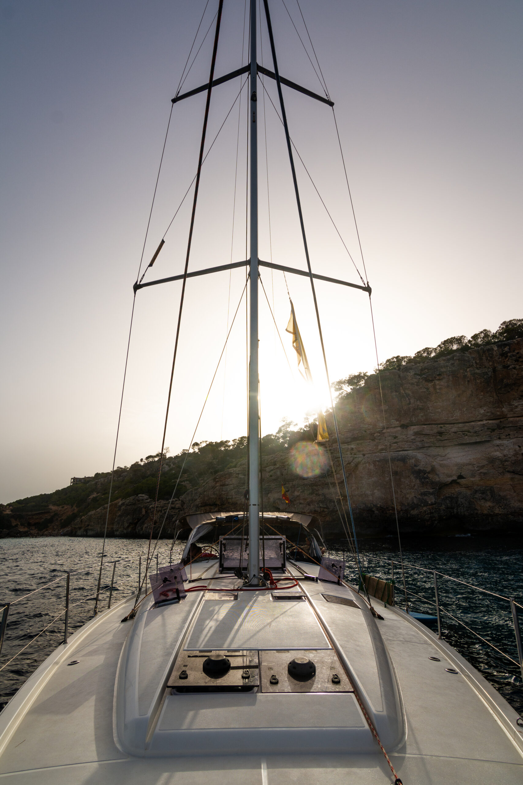 A sailwithus yacht sailing off the coast of Mallorca in clear blue water